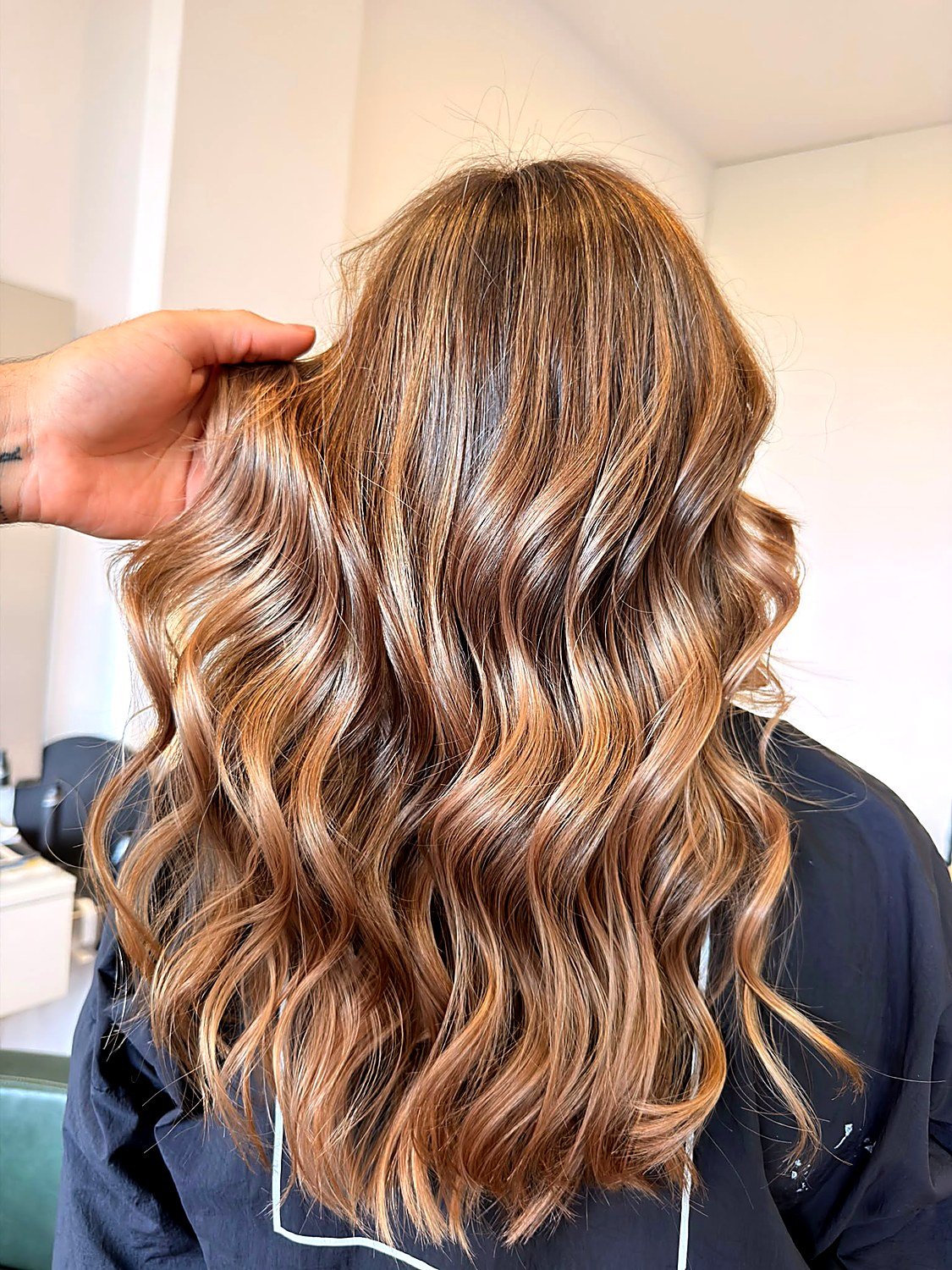 Caramel hair colour with dimensional highlights and waves at She. Porto